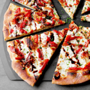 prosciutto pizza slices on peel
