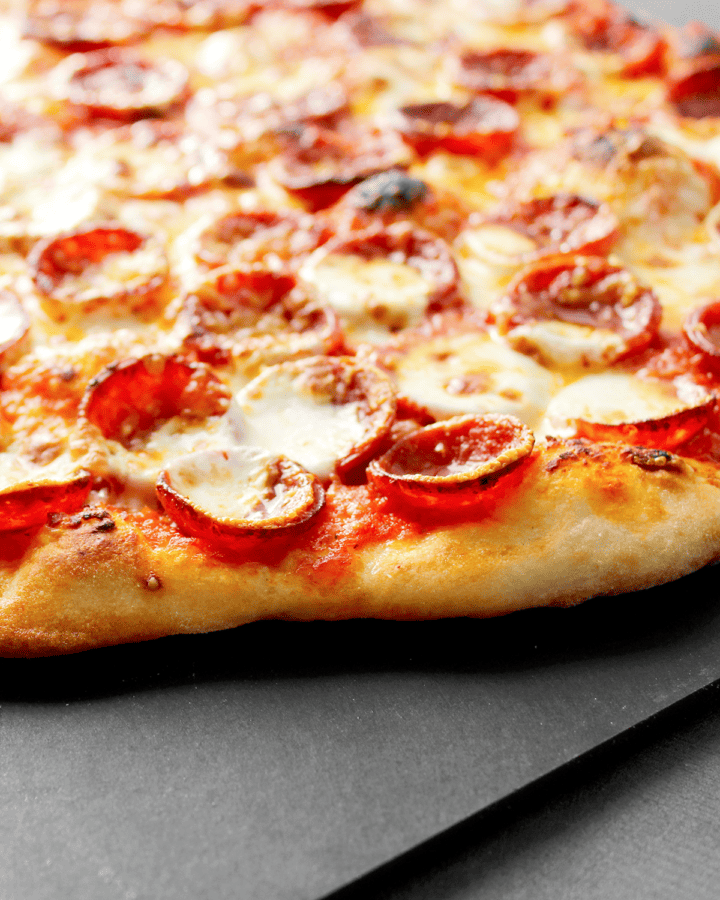 pepperoni cups on baked pizza