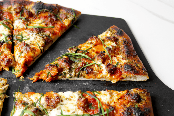 Italian sausage pizza with pesto and marinara sauce