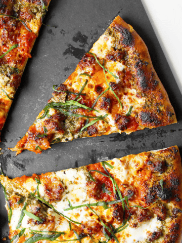 Italian sausage pizza with pesto and marinara sauce