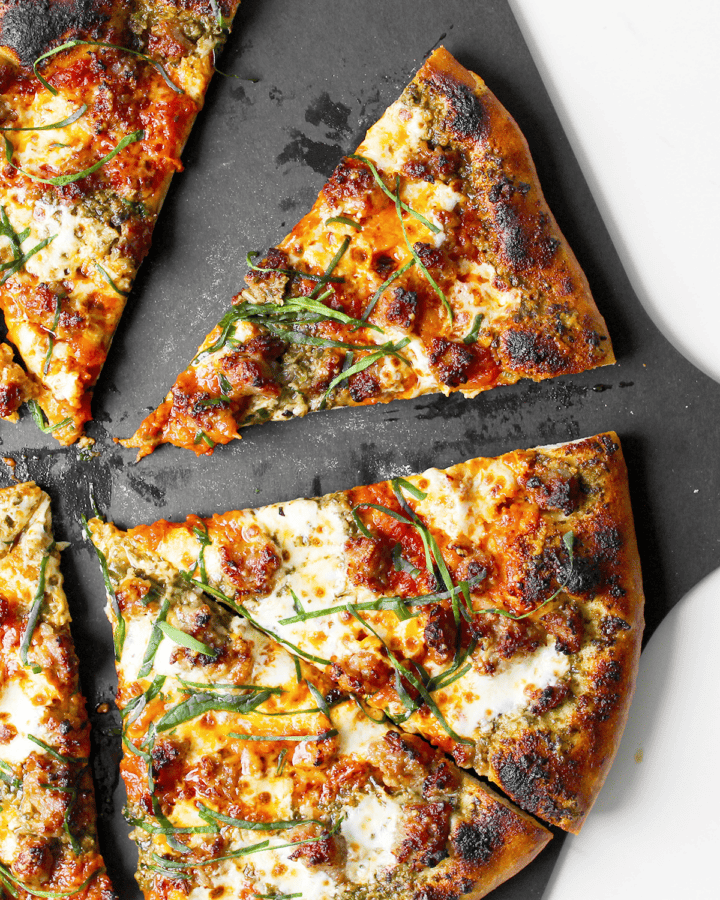 Italian sausage pizza with pesto and marinara sauce